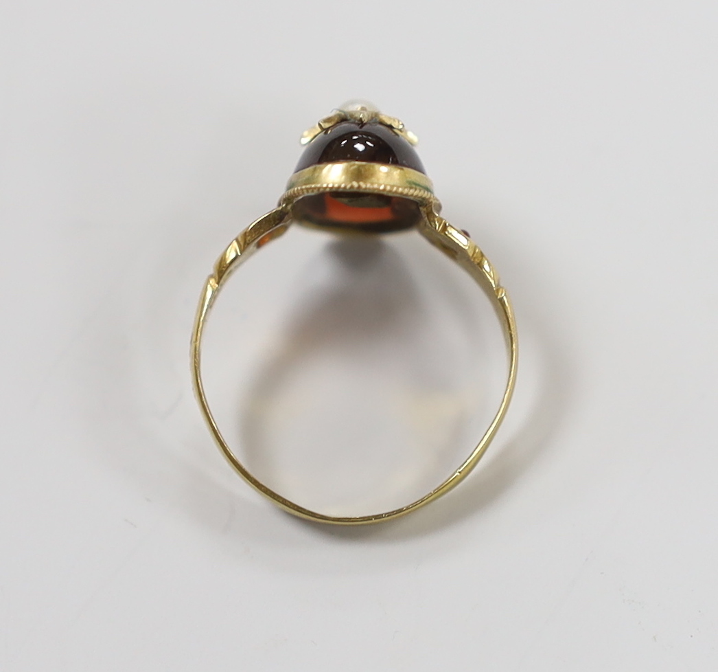 An Edwardian 18ct gold, cabochon garnet, split pearl and gem set ring, size N, gross weight 2.7 grams, with original box.